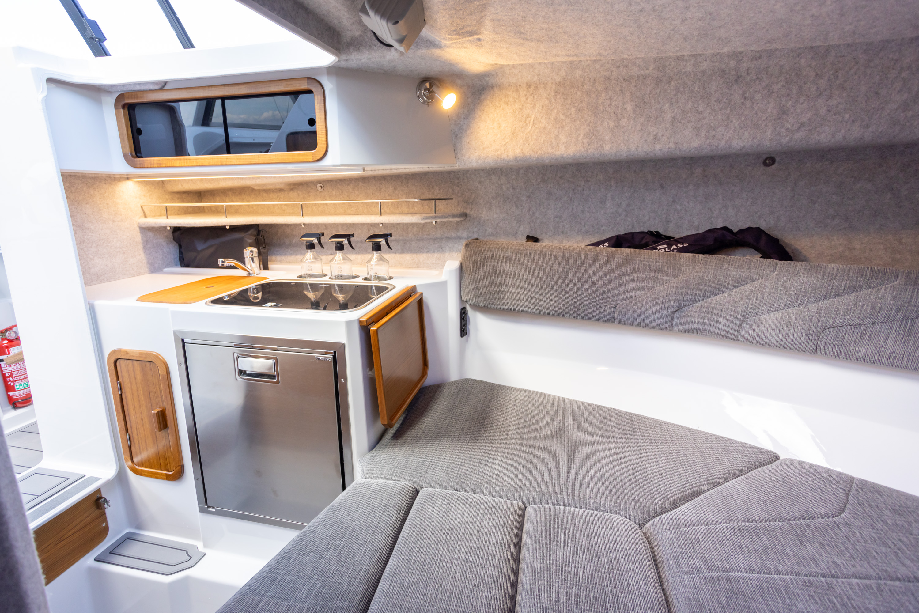 A fully appointed galley with 50L electric fridge, hot and cold fresh water plus a twin hob gas cooker and ample storage